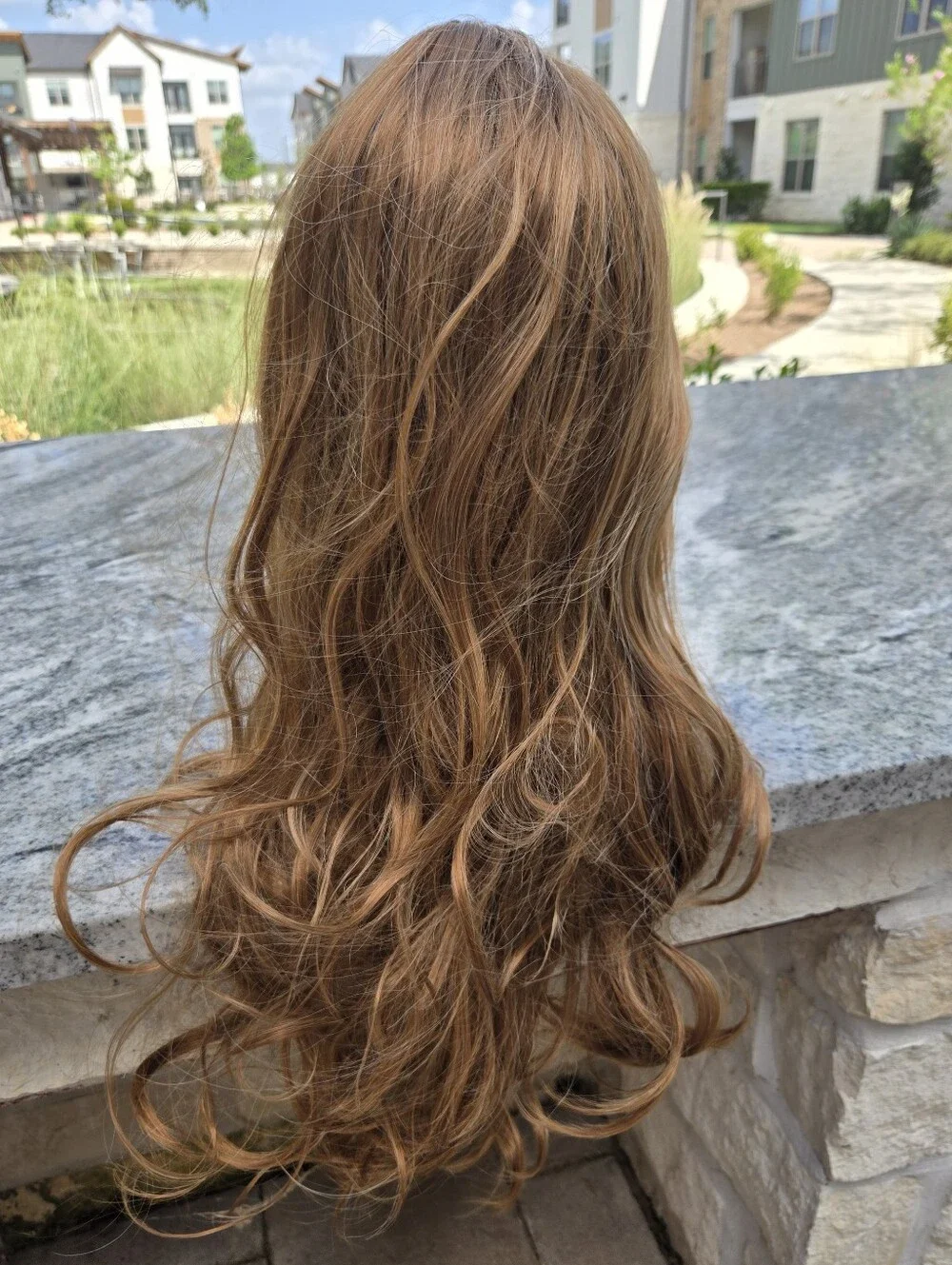 Women's long, wavy synthetic wig in a light brown/honey blonde Light Curls